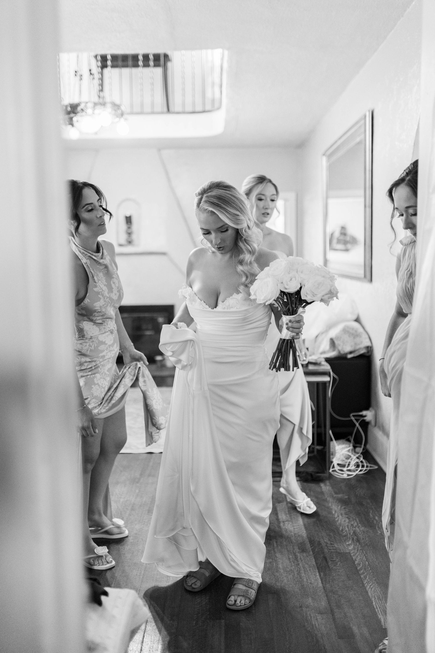 A black and white photo series showing wedding preparations with people getting ready in an indoor setting.