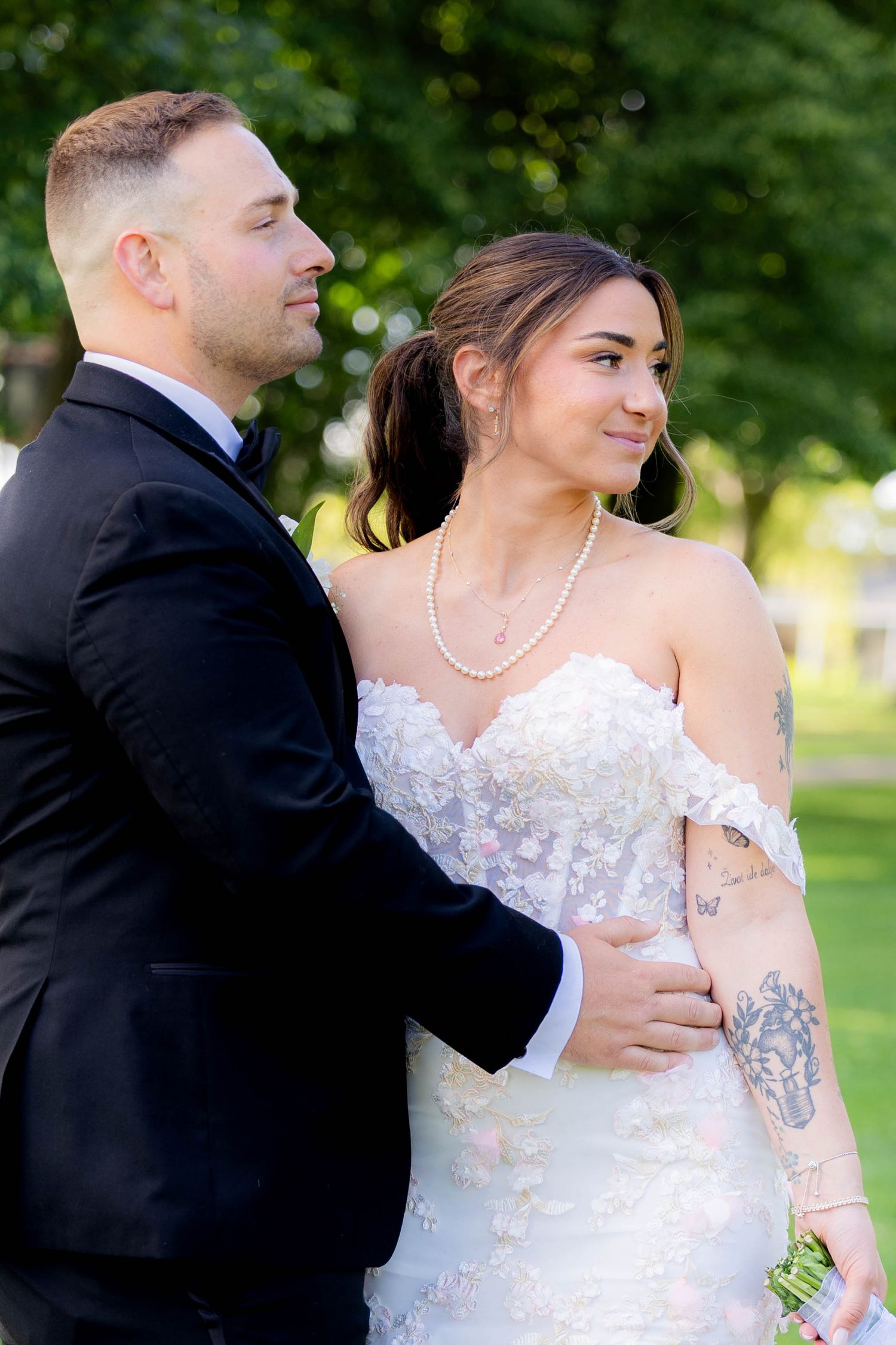 A series of candid wedding photos showing a couple embracing outdoors in formal attire against a green garden backdrop.