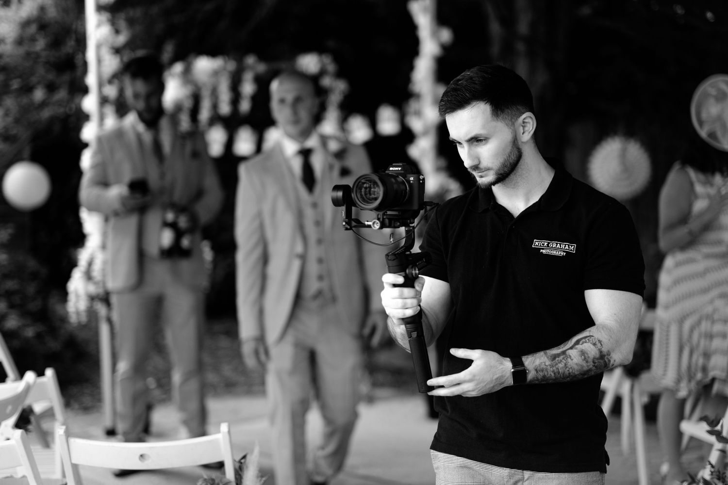 Wedding videographer in action, intimate marquee wedding. Lichfield