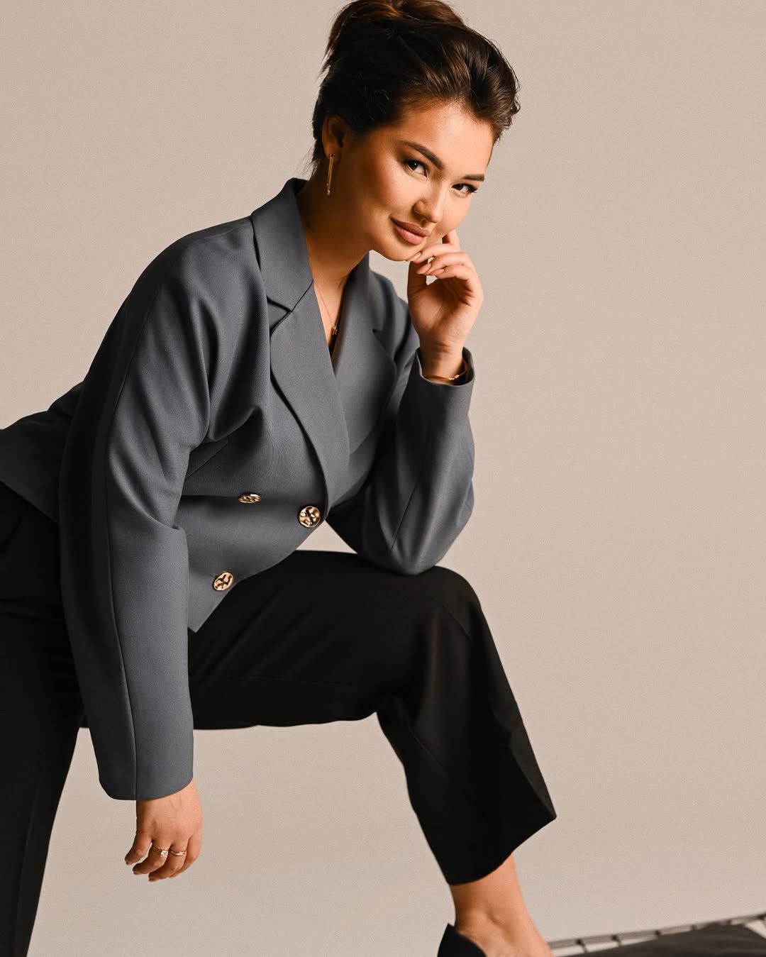 A sophisticated business portrait of a woman in a blazer, designed to communicate professional expertise to investors.