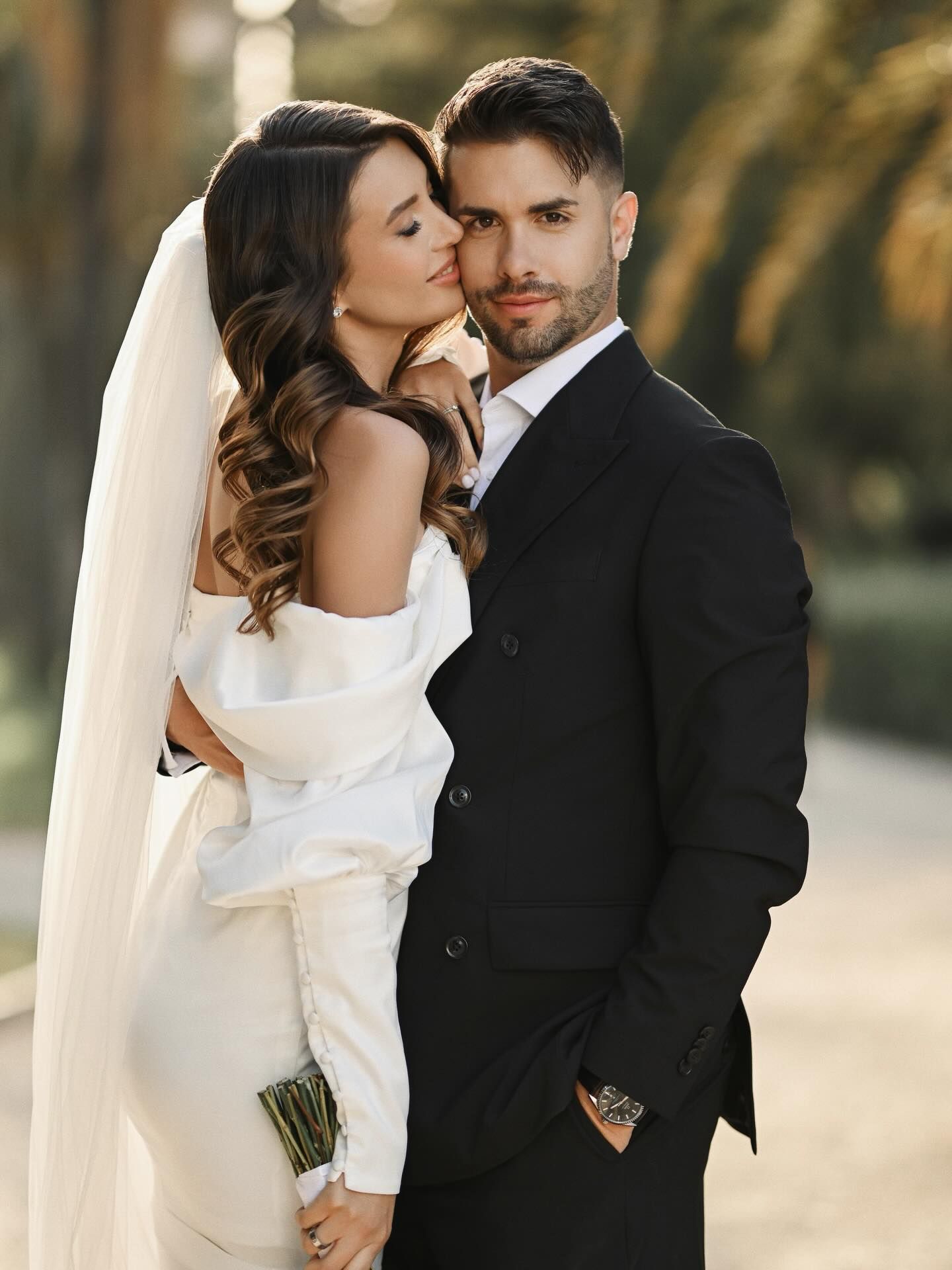 An intimate close-up portrait of a bride gently leaning against her groom during an elegant wedding session in Valencia gardens.