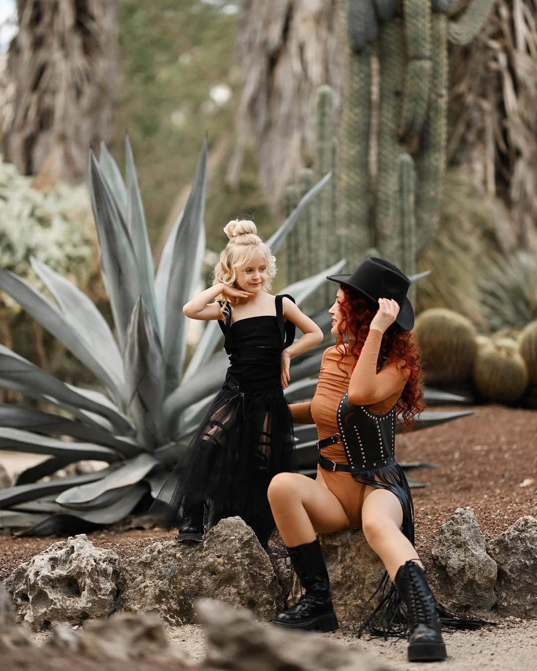 A mother and daughter posing together surrounded by unique desert flora at the Valencia Botanical Garden.