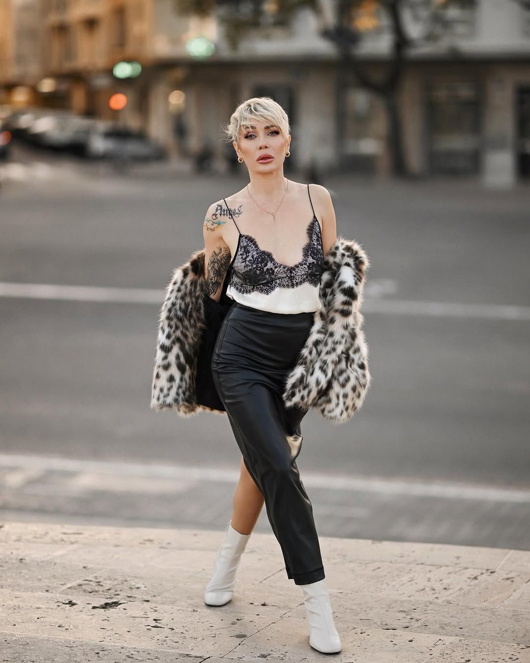 A luxury blonde woman walking confidently down a street in a professionally curated outfit for an all-inclusive experience.