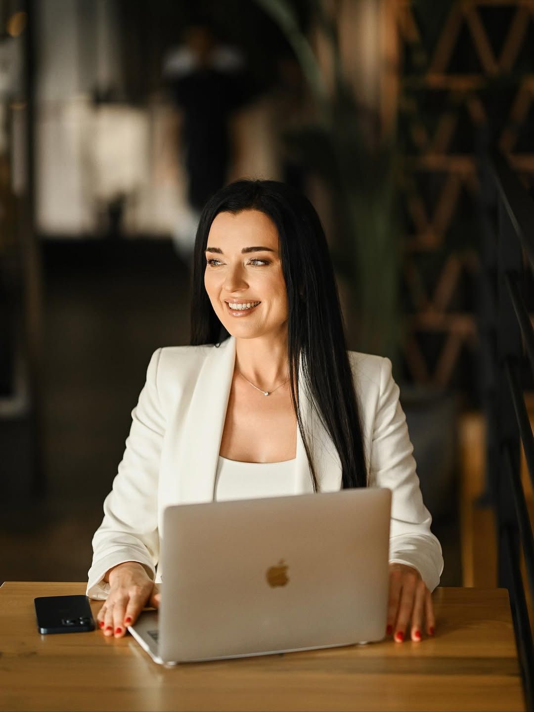 A professional mentor working at a desk, capturing her in her element for an authoritative personal brand.