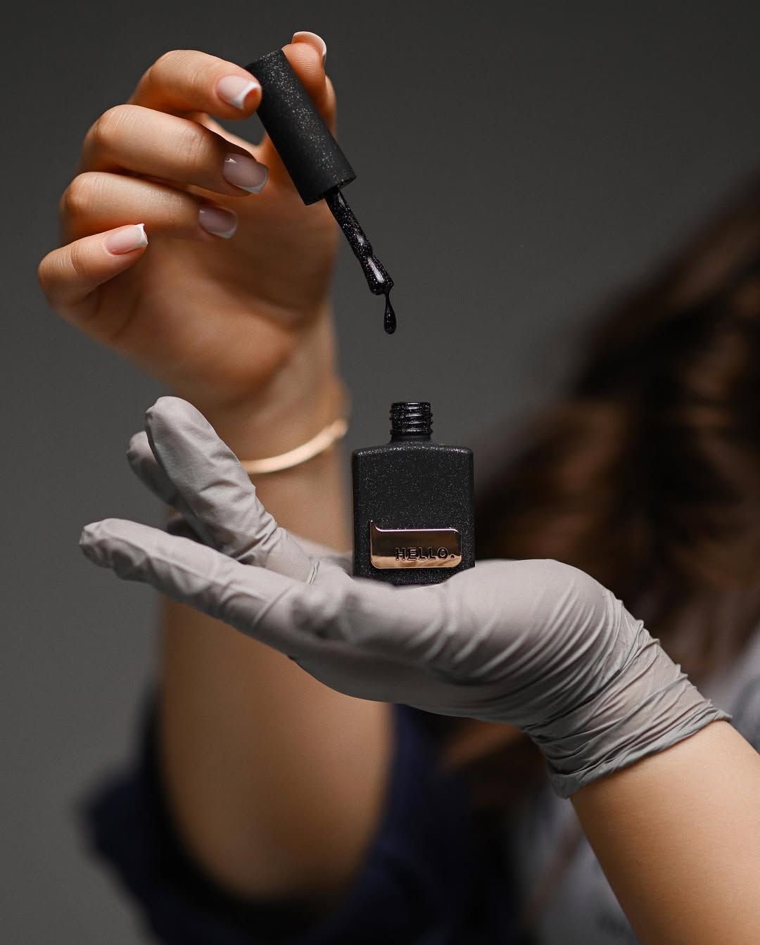 A nail technician applying polish with artistic precision, capturing the 