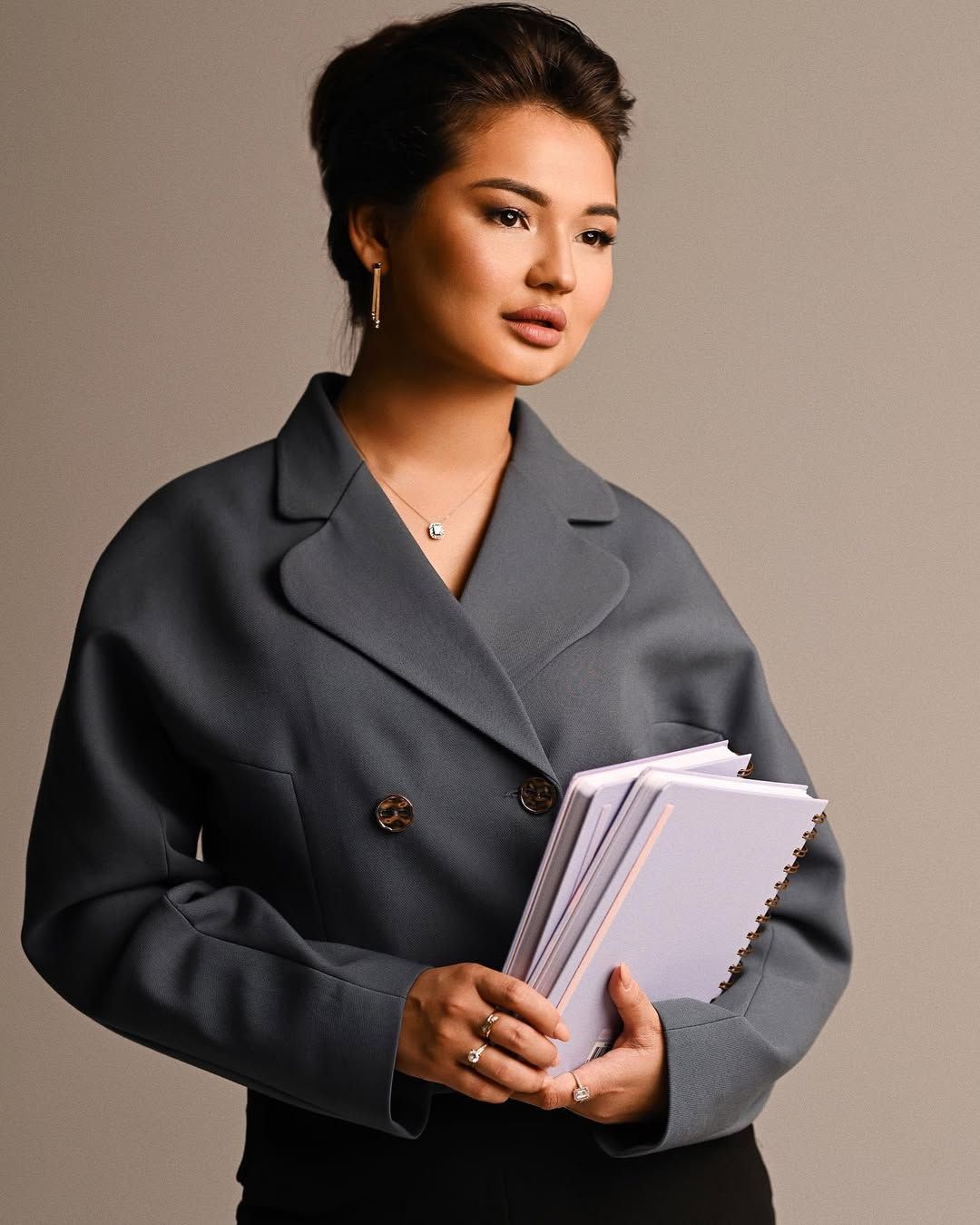 An entrepreneur holding planners, highlighting organization and craftsmanship in professional strategic business photography.