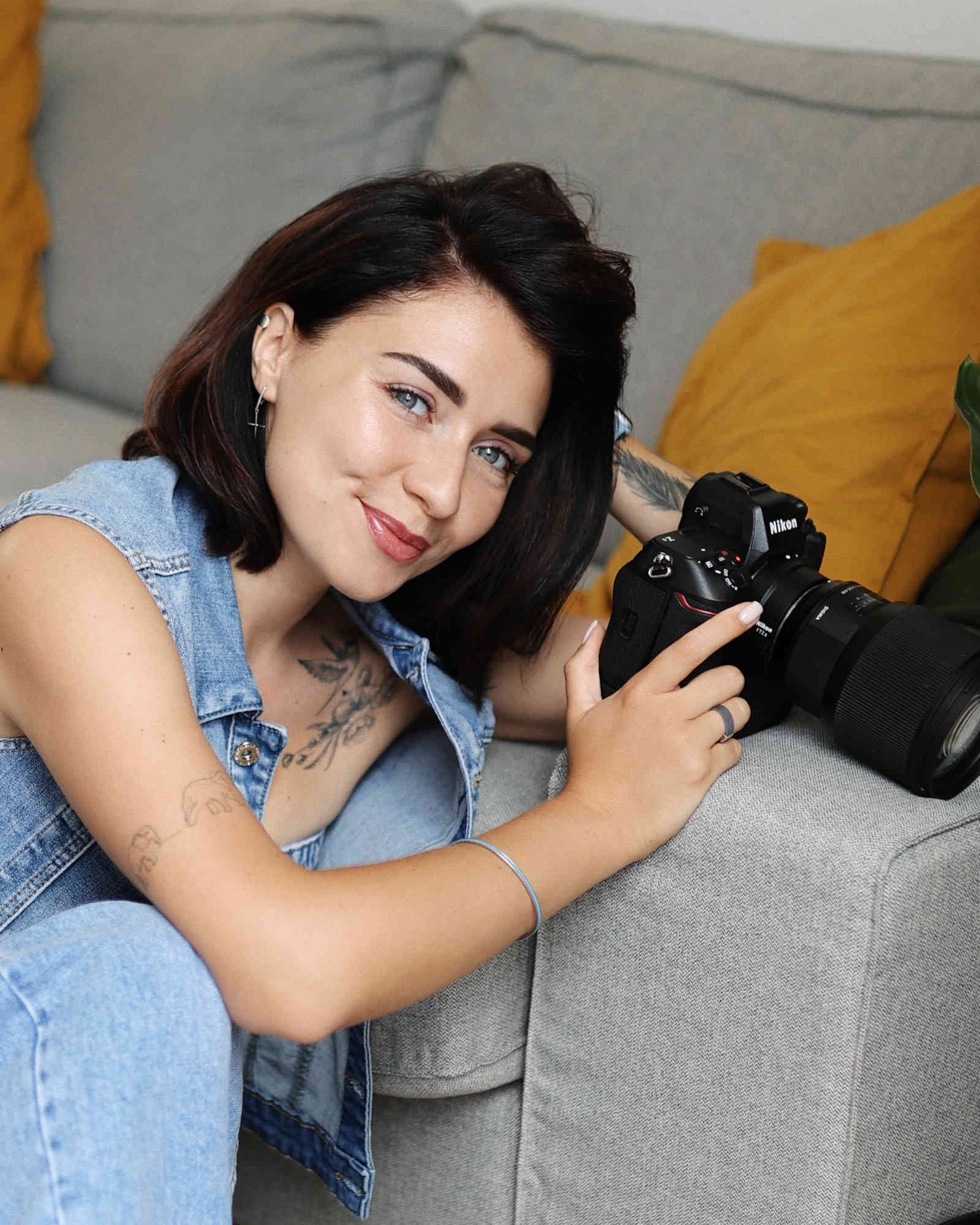 Portrait of professional lifestyle and editorial photographer Darina Derzkaya holding a camera for her about section.