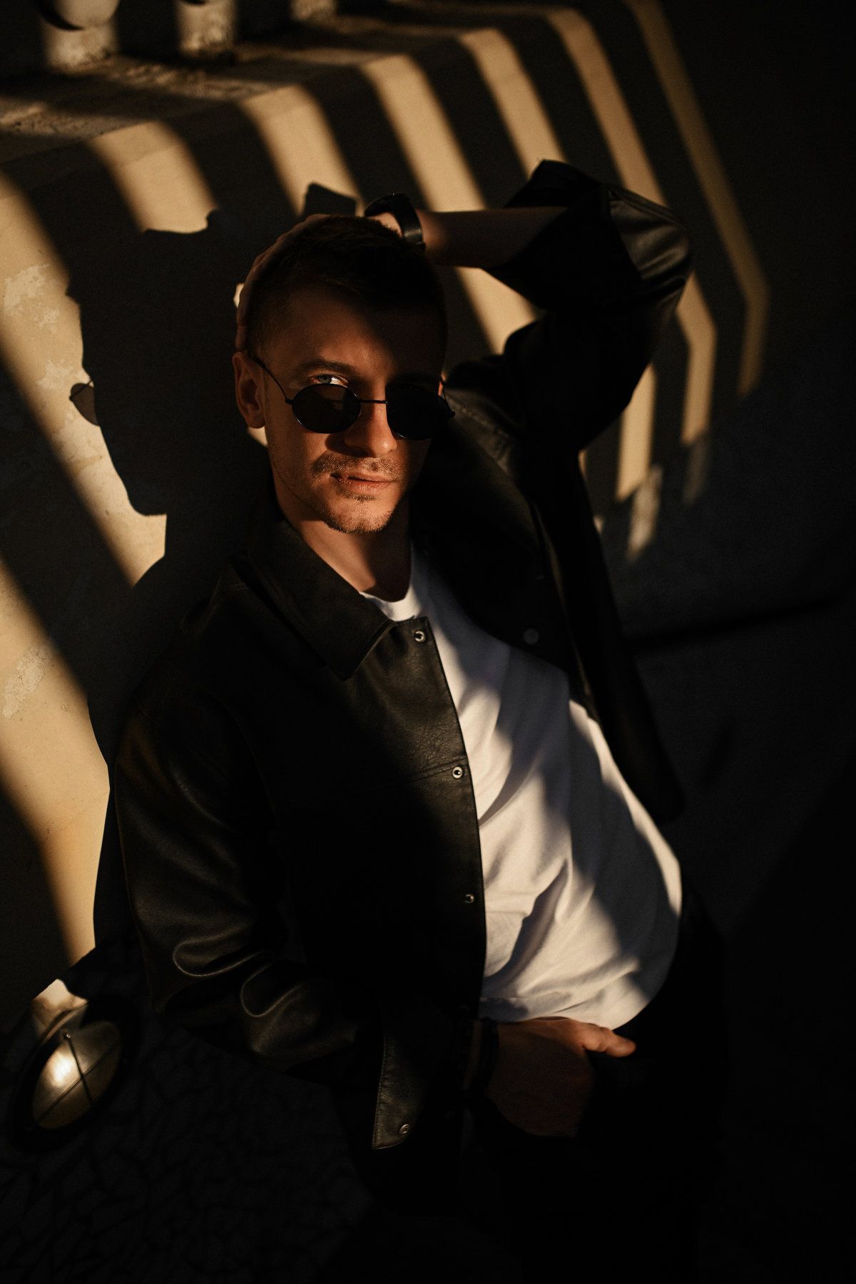 Geometric male photo session utilizing the harsh rhythm of light and shadows at the City of Arts and Sciences in Valencia.