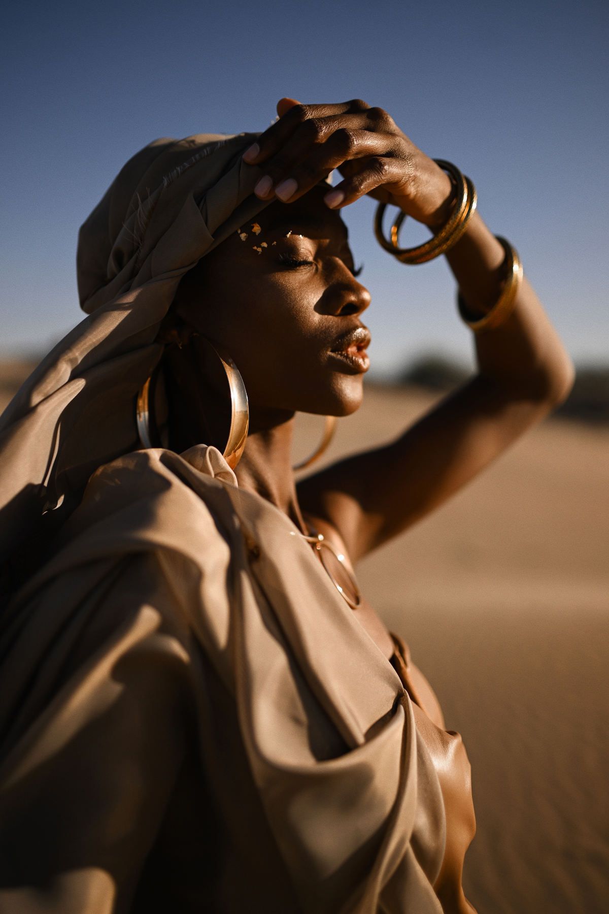 A cinematic video portrait of a woman in ethnic styling posing under the warm Mediterranean sun during an outdoor session in Valencia.