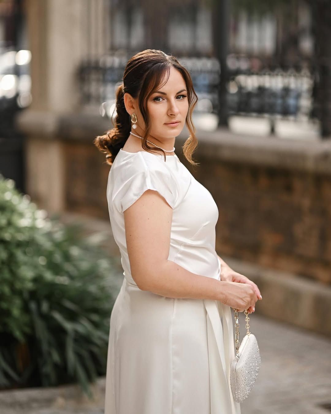 Woman enjoying a relaxed stroll through the historic streets of Valencia during a stylish personal portrait photoshoot