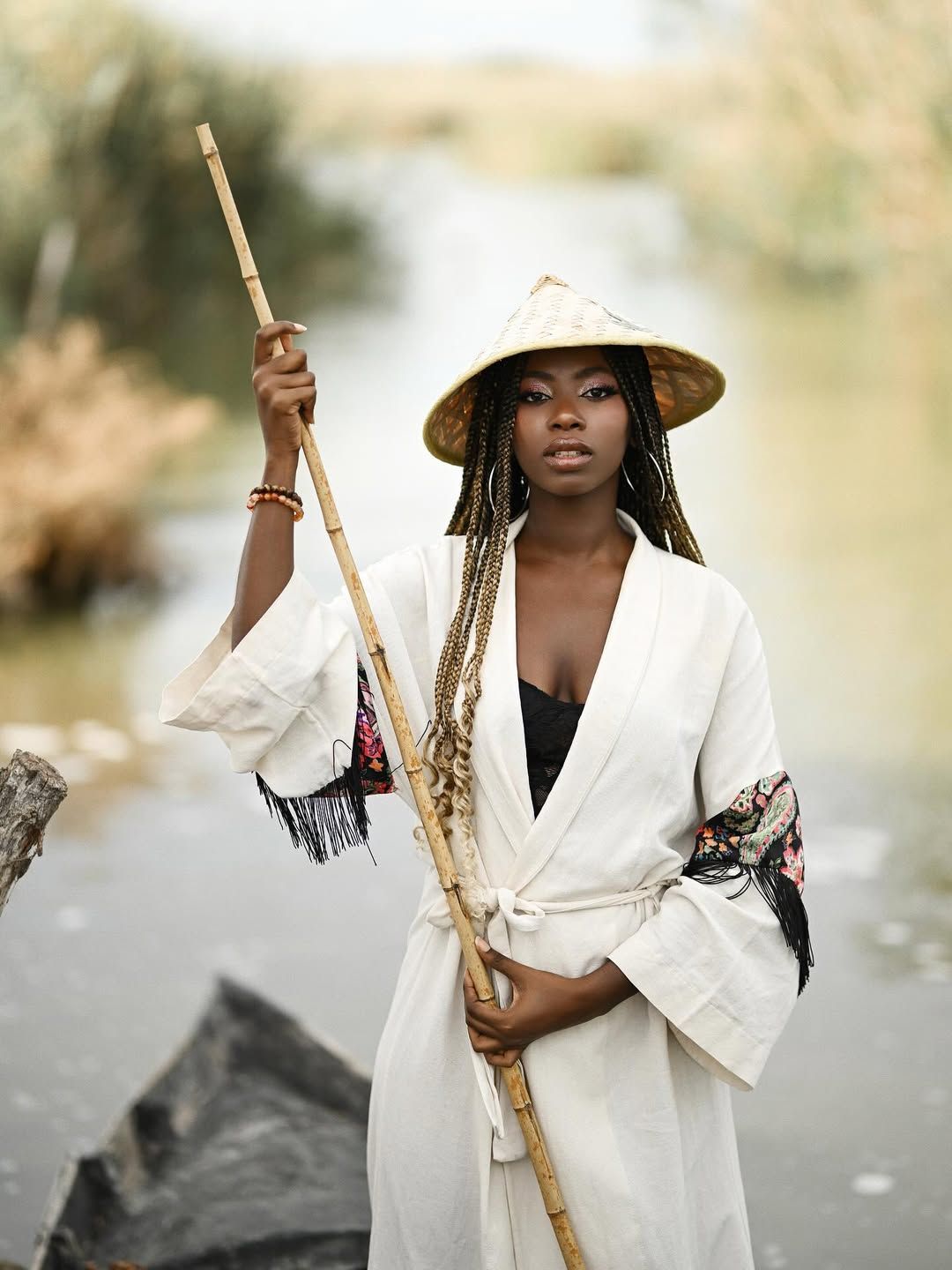 Cinematic portrait of a woman standing in a moving wooden boat along the narrow river channels of Albufera park