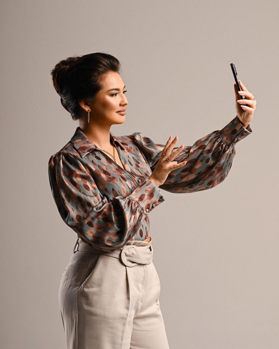 An entrepreneur using a smartphone in a business setting, showcasing a dynamic and modern corporate image for media kits.