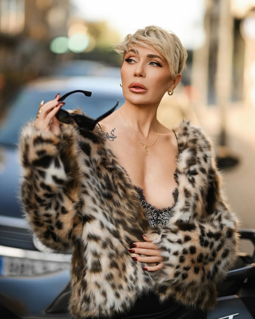 A premium medium portrait of a well-styled woman with sunglasses, showcasing an exclusive, high-end look on location.