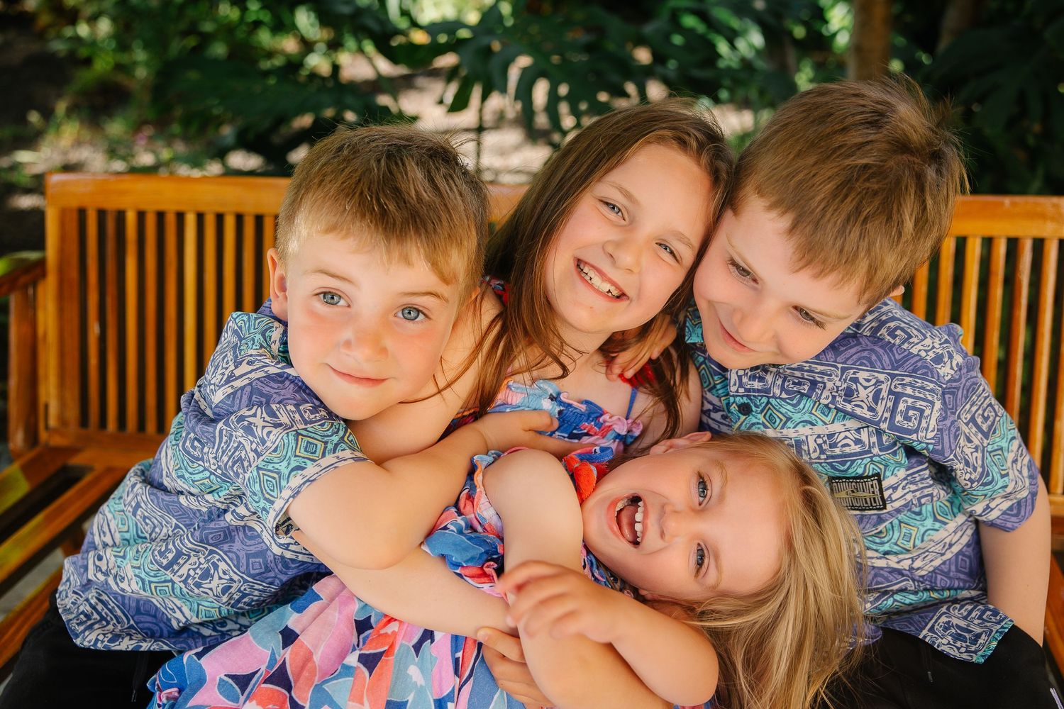 Playful family portrait session showing close-up expressions and matching outfits.
