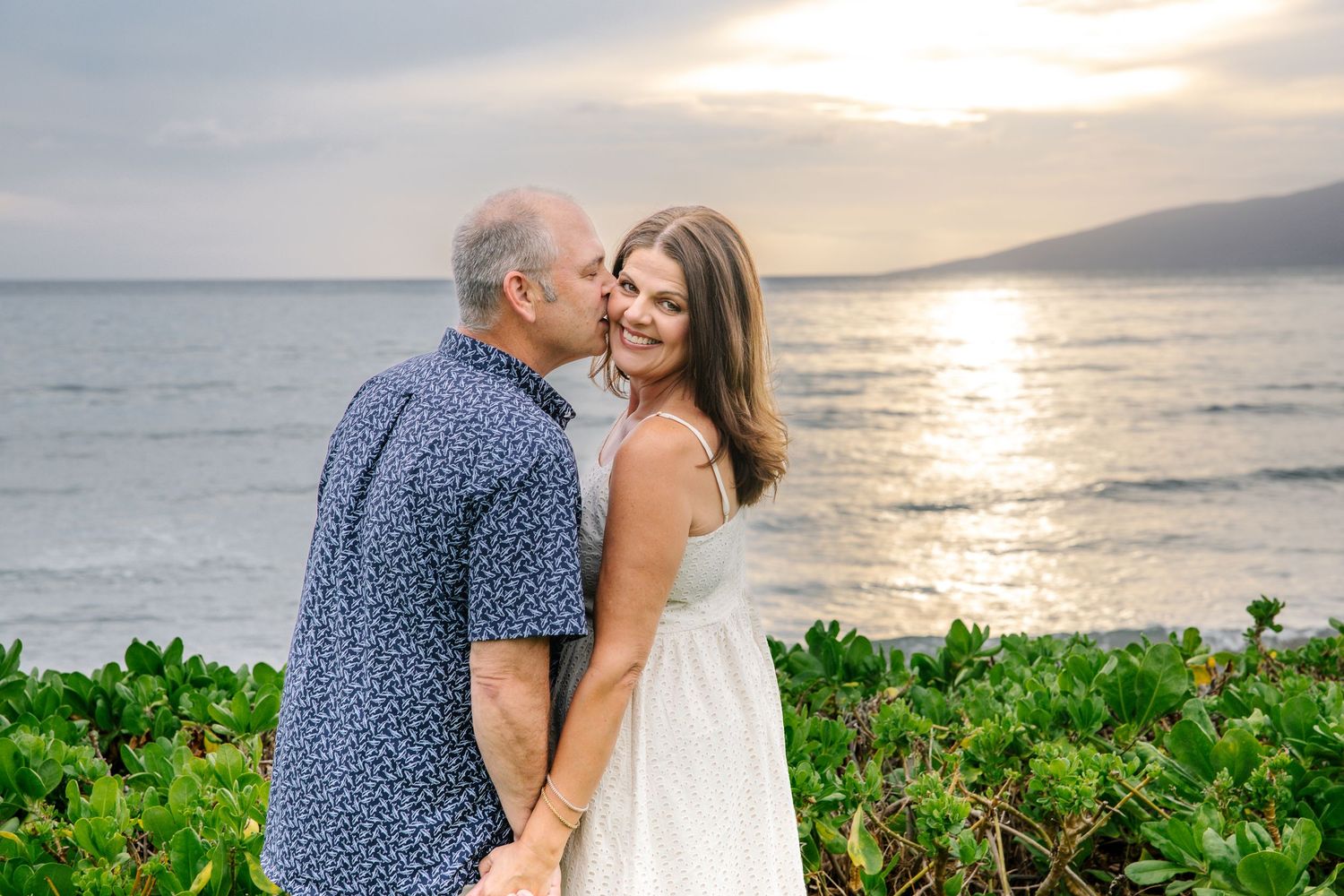 Romantic sunset portraits on a tropical beach with palm trees and ocean views.