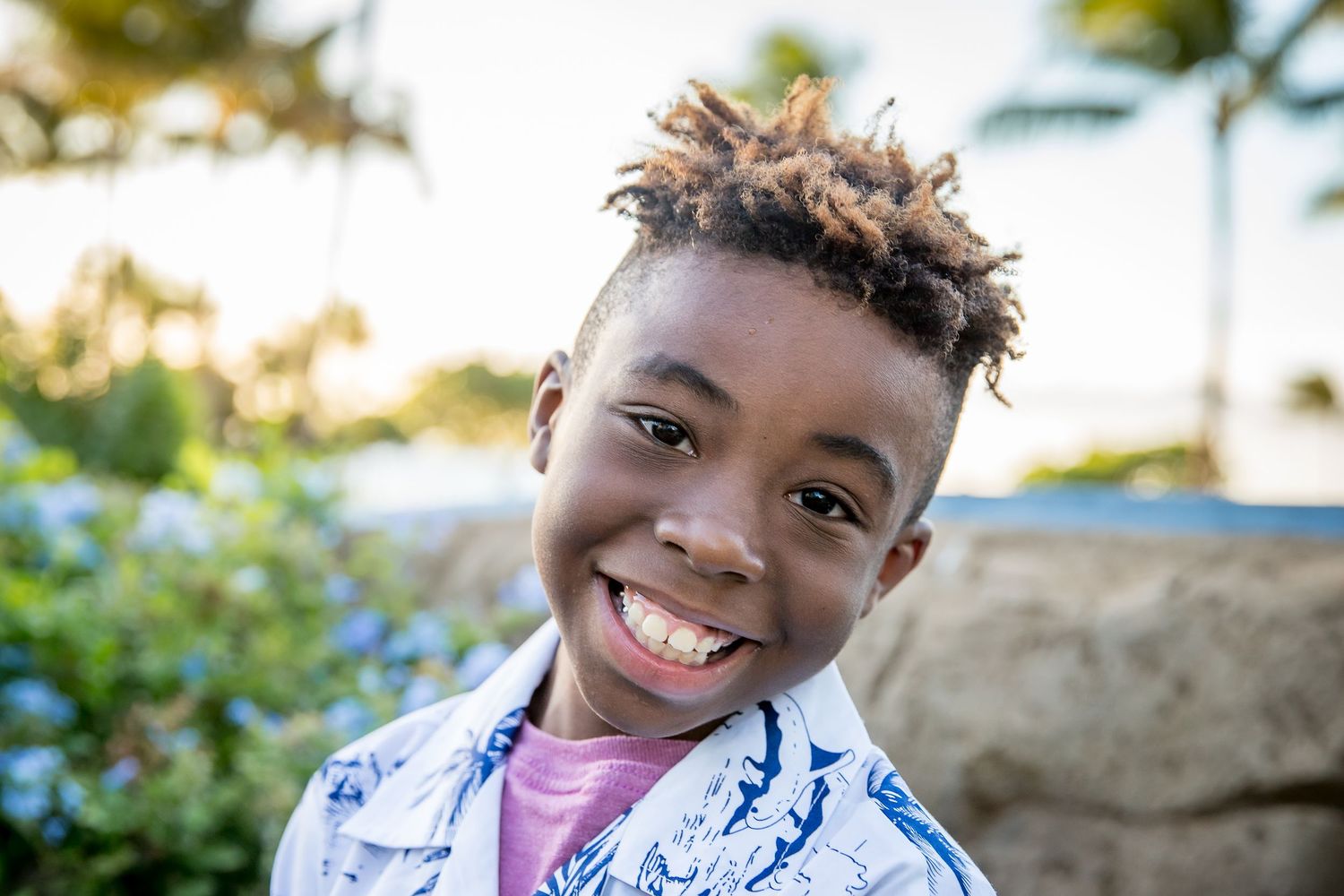 A series of five photos showing a smiling person in various poses outdoors against a sunny background.