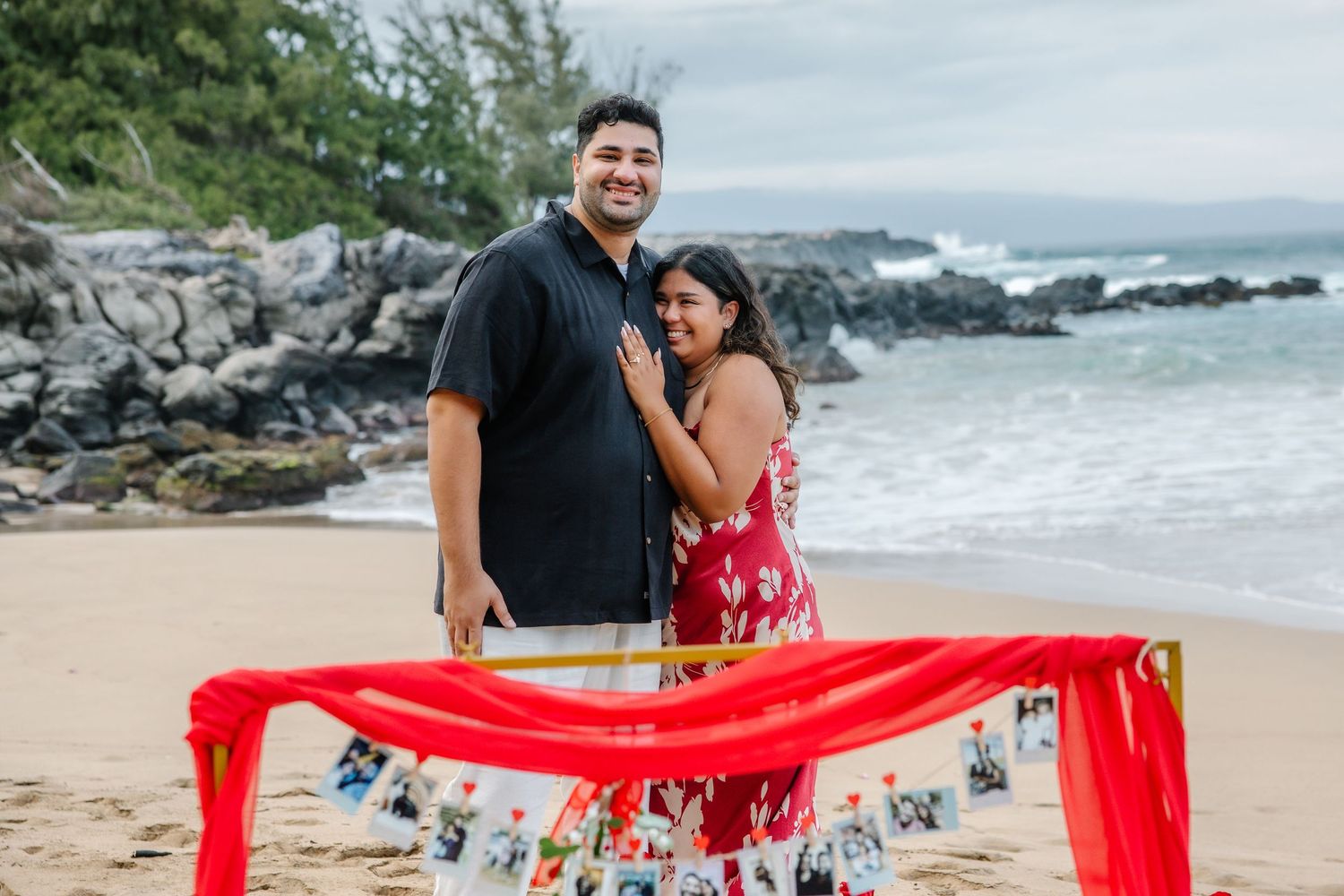 A joyful celebration on the beach with a red banner and decorative elements.