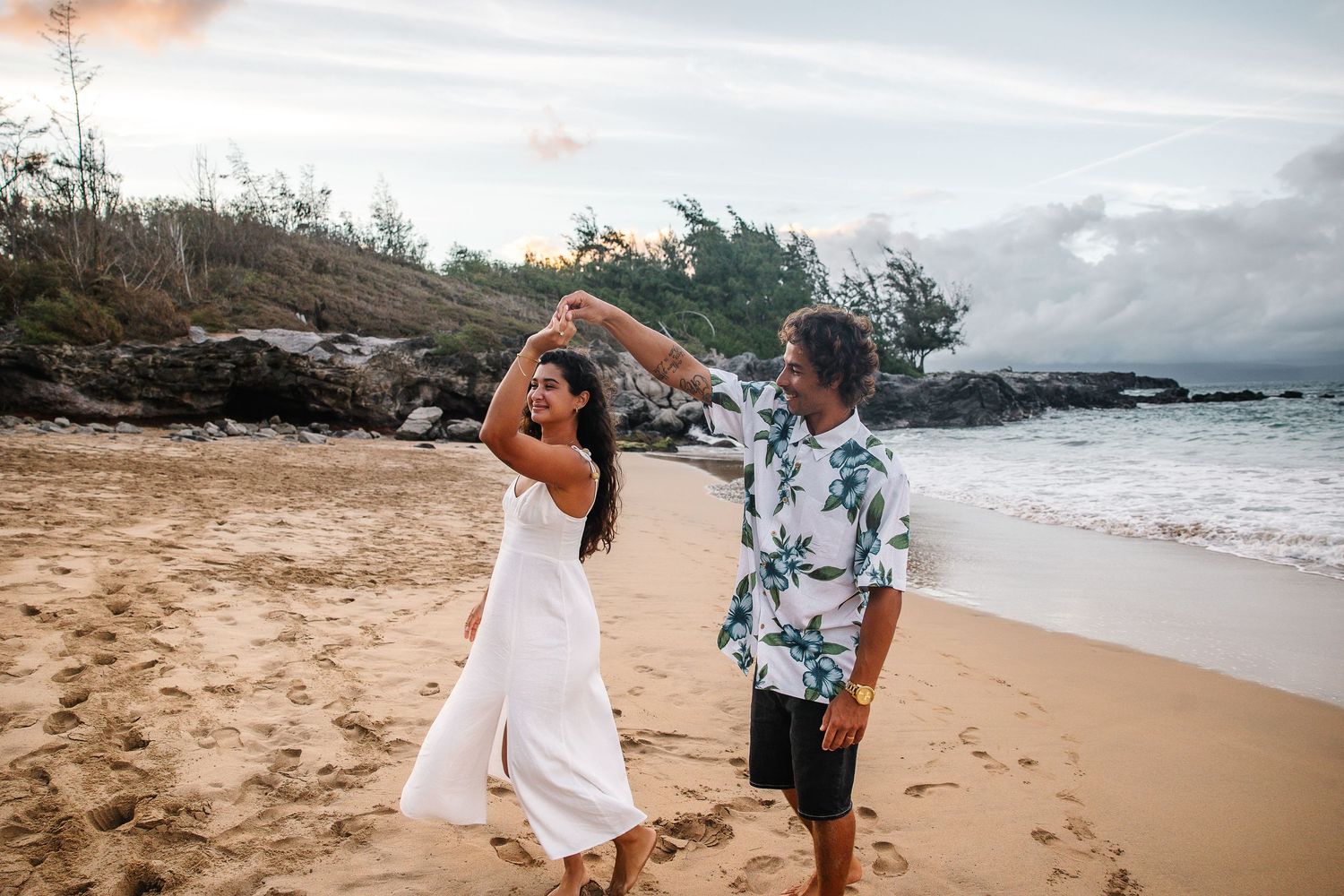 Beach wedding celebration with tropical floral details and ocean backdrop.