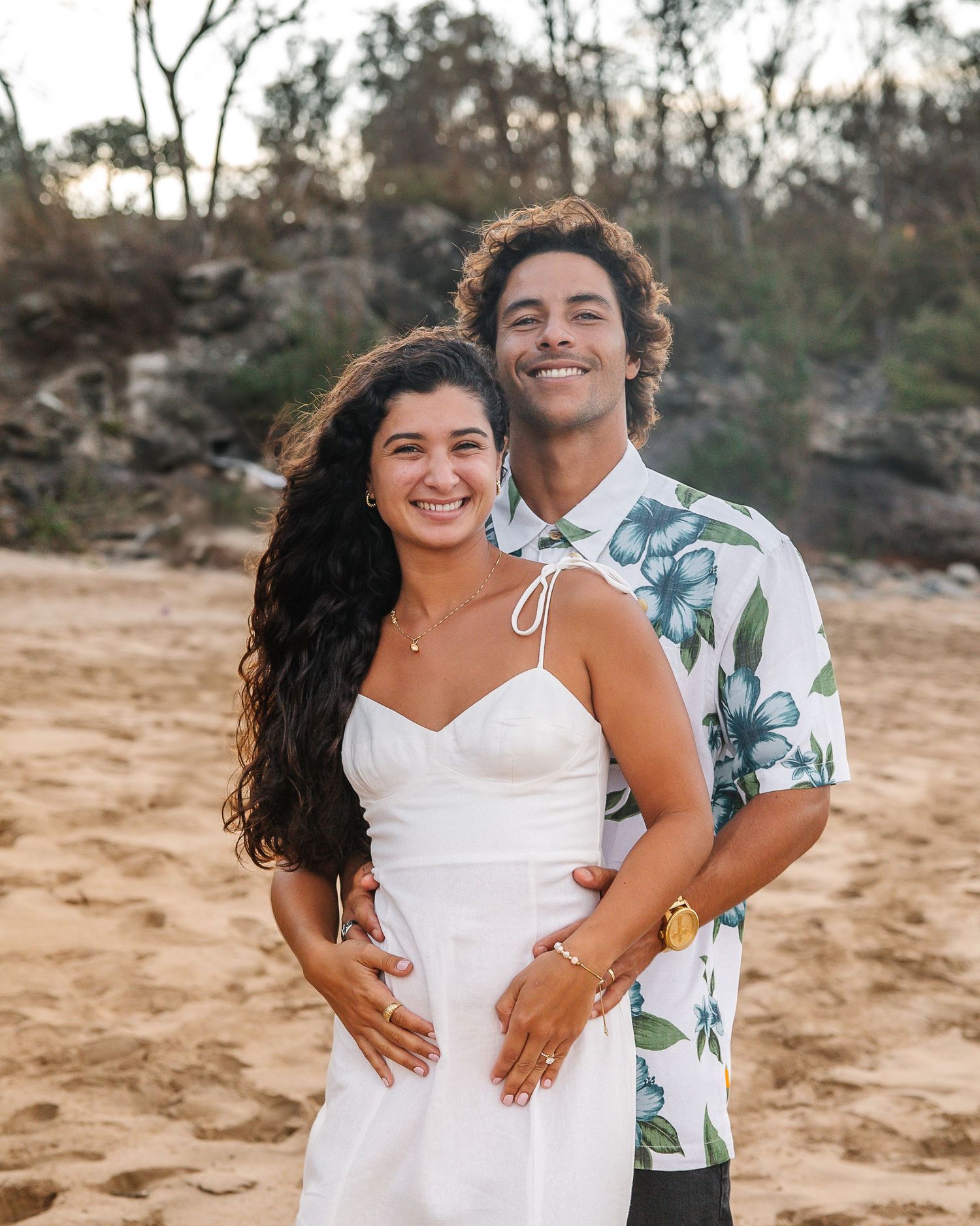 Joyful couple shares loving moments together during a beach photoshoot in Hawaii.