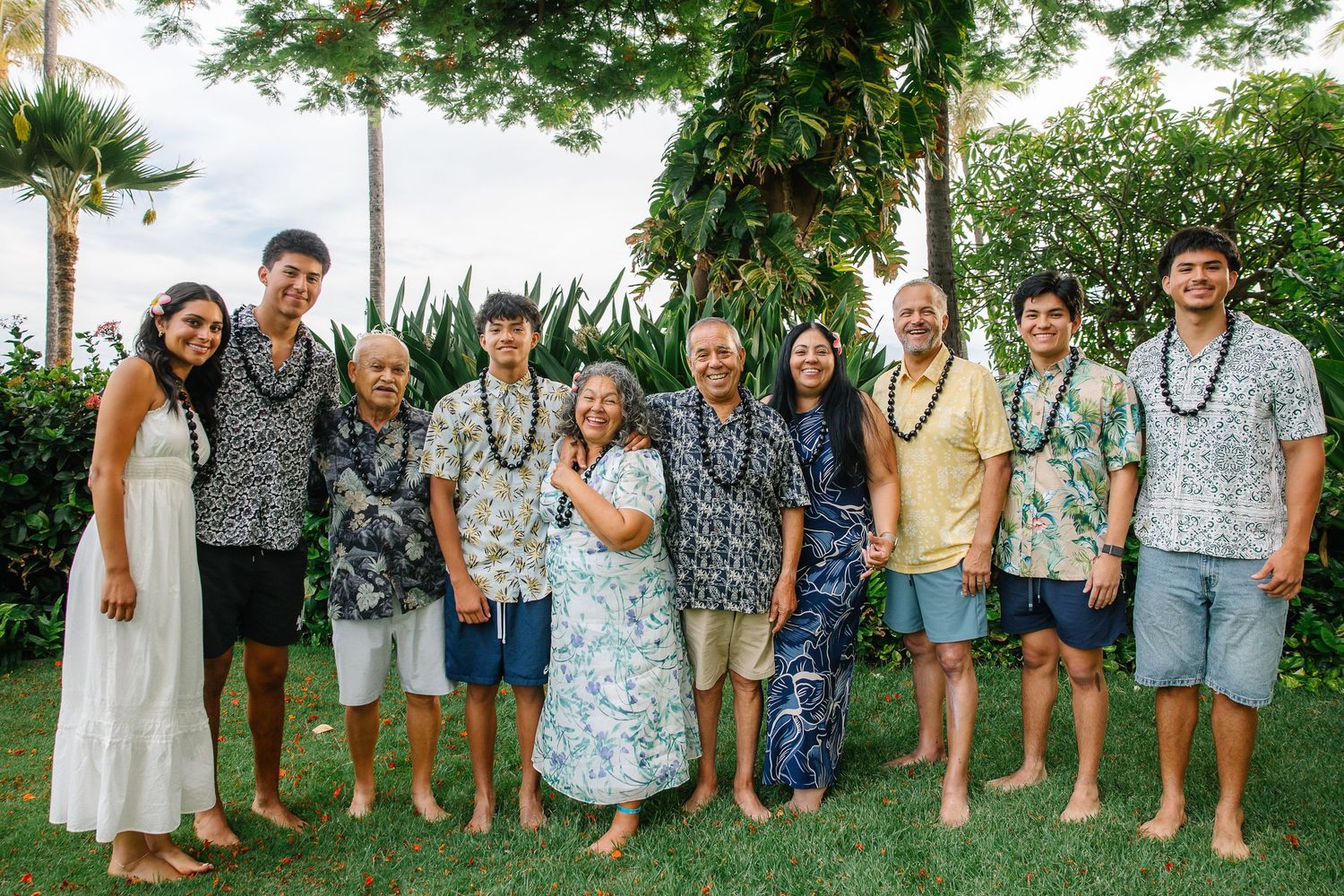 Group photo of people wearing coordinated blue and white outfits standing together outdoors.