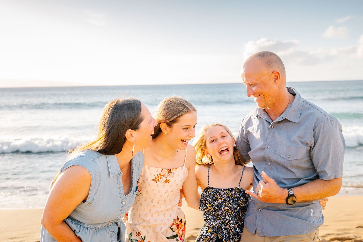 Candid family moments captured during sunset beach photography session.