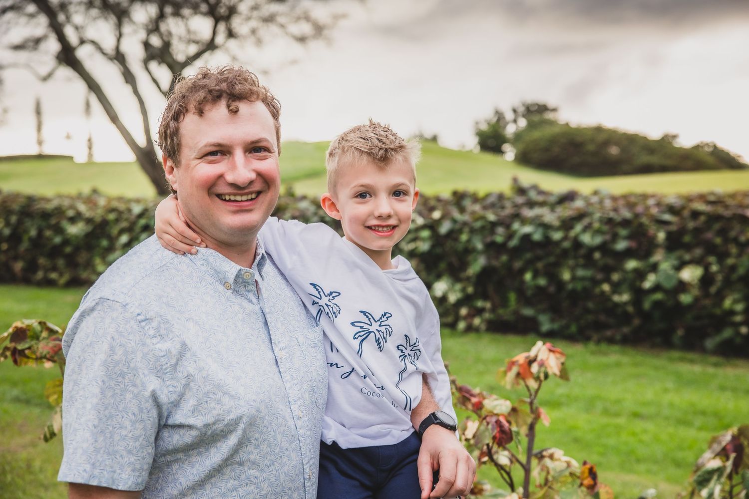 A heartwarming outdoor portrait in a green garden setting.