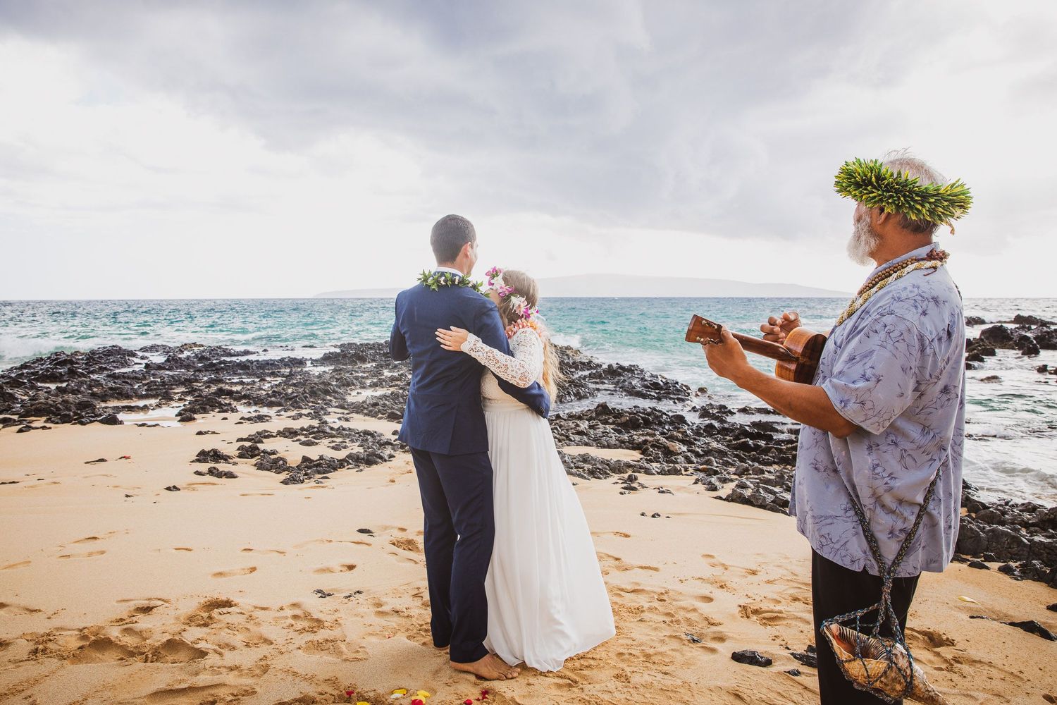 A beachside wedding ceremony with ukulele music on a Hawaiian shore.