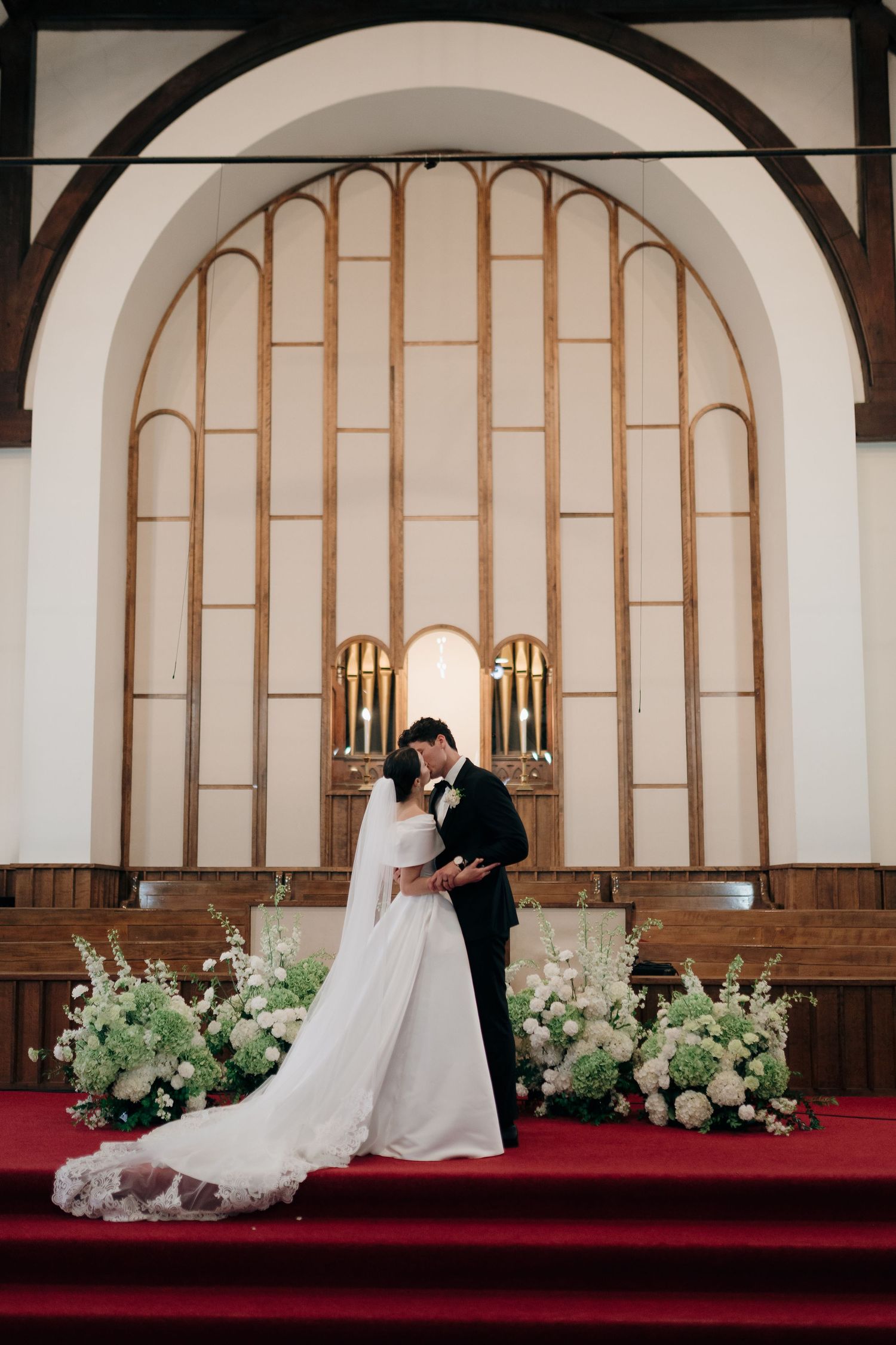 A romantic wedding ceremony sequence showing a couple in a church with elegant arched windows and floral decorations.