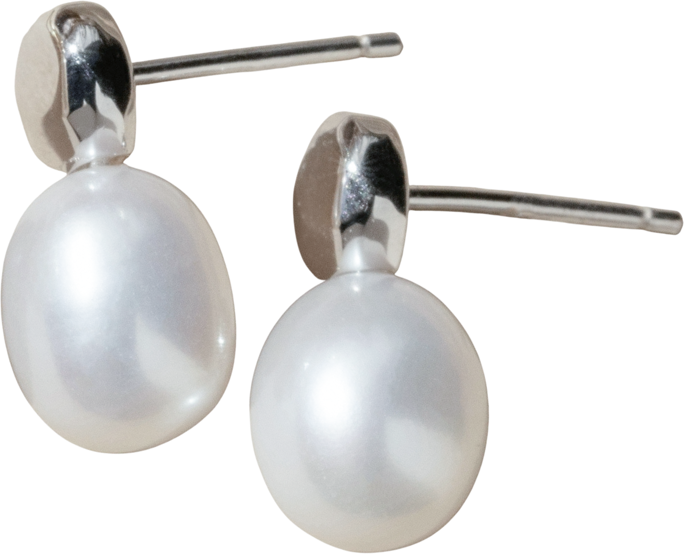 Sterling silver stud earrings featuring oval white freshwater pearl drops with polished silver settings.
