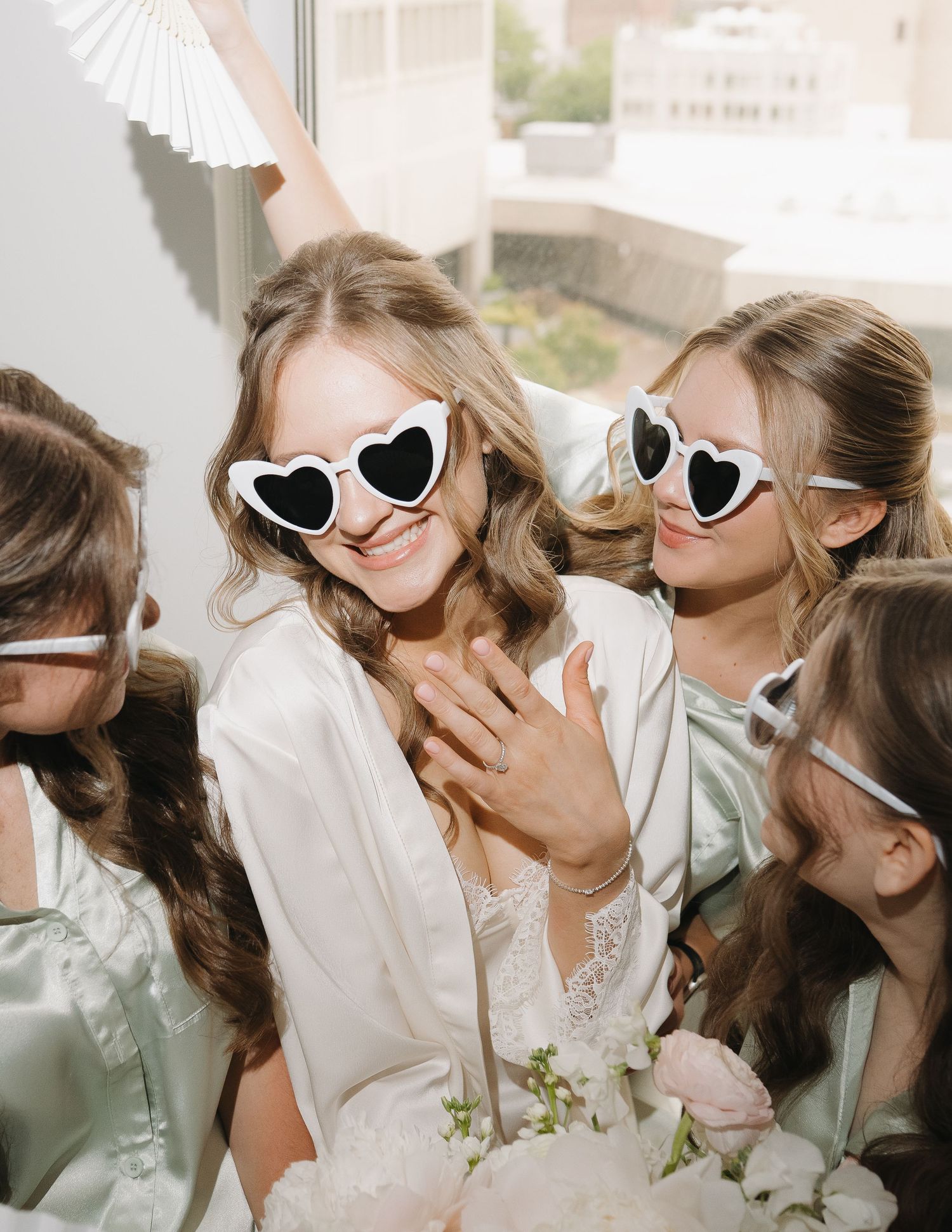A group of friends in heart-shaped sunglasses share joyful moments together in a candid photo series.