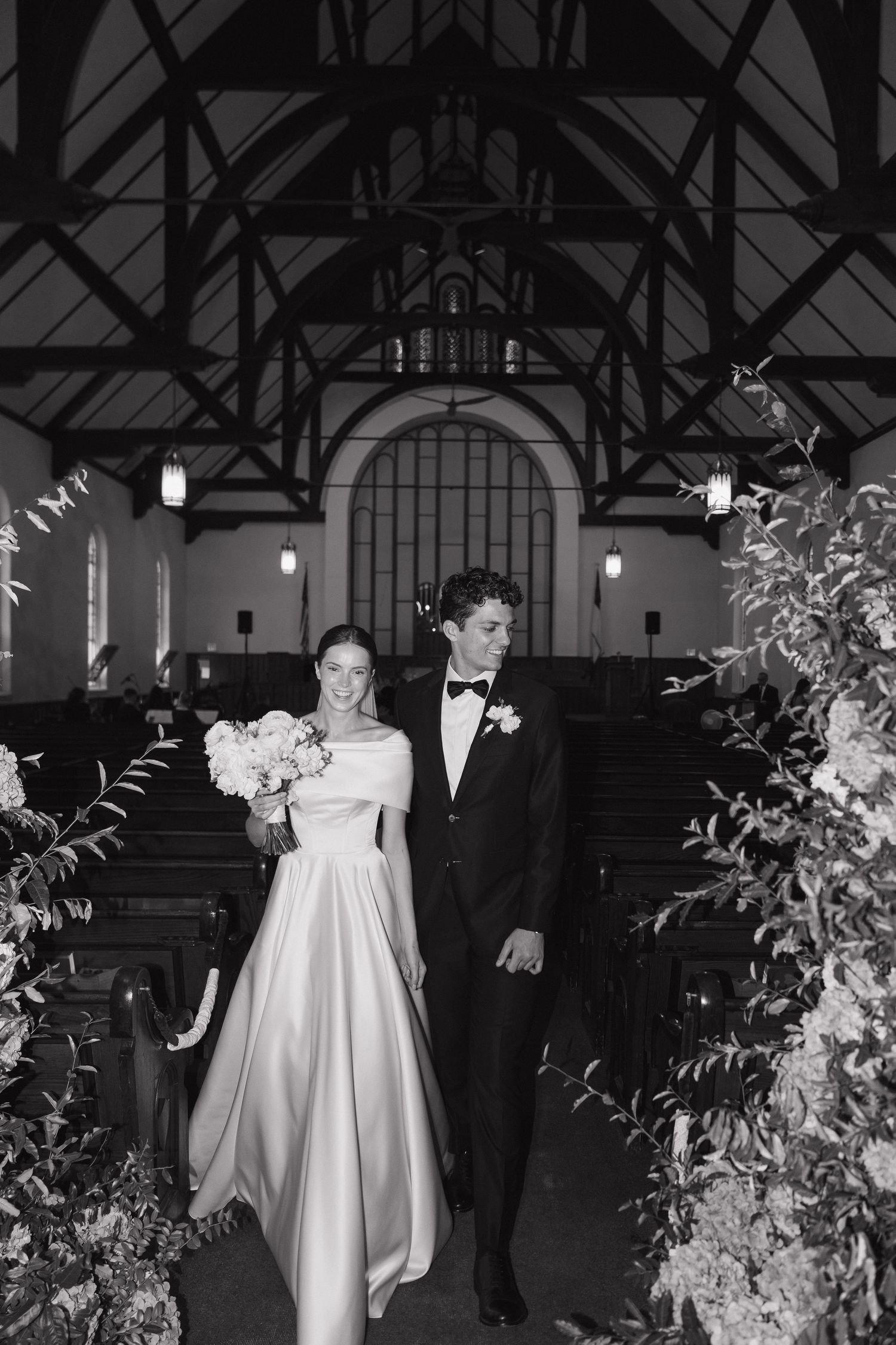 A black and white photo series showing a wedding ceremony in a church with floral decorations.