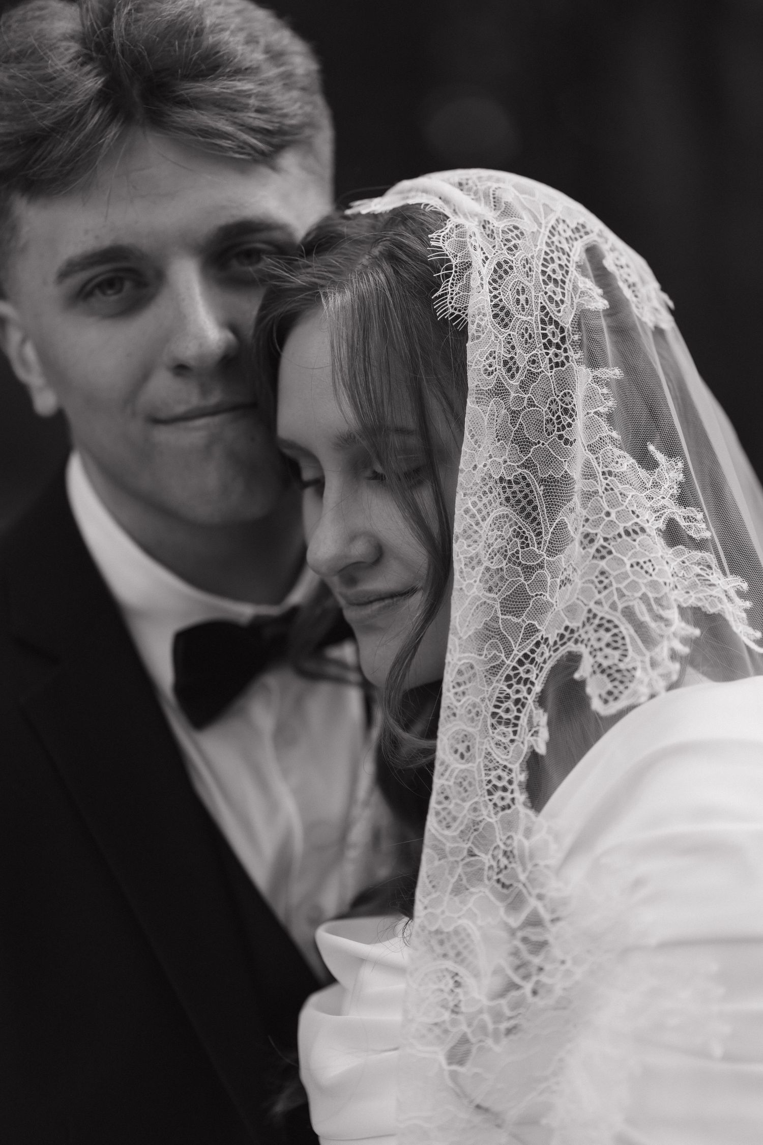 Black and white intimate wedding portraits showing tender moments between newlyweds.