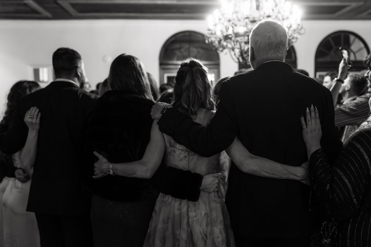 A black and white photo shows a crowded dance floor with couples dancing together at an event.