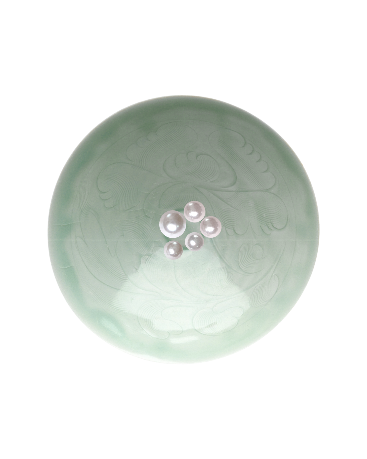 Celadon green ceramic bowl with embossed floral design and small pearl embellishments at center.