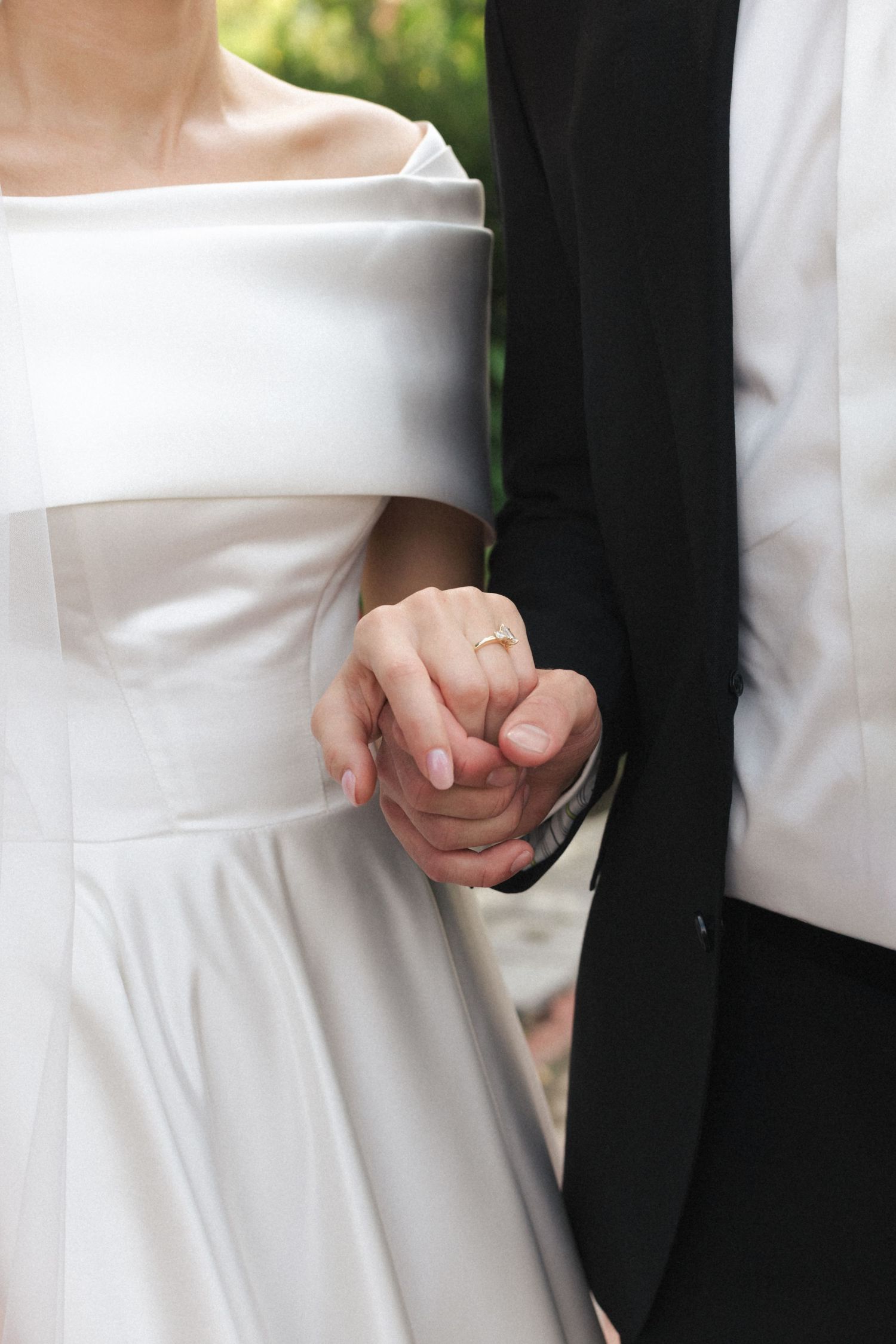 A close-up detail shot of hands holding during a wedding ceremony.