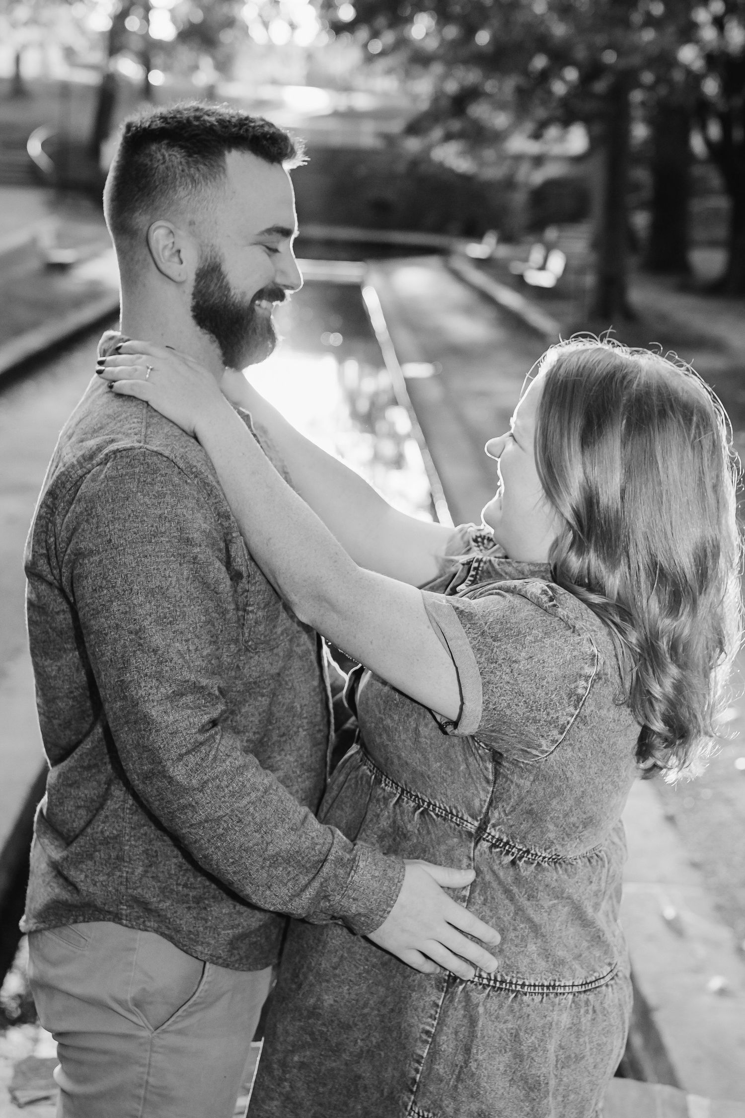 Romantic engagement photo of a couple walking hand-in-hand through downtown Lititz, Pennsylvania