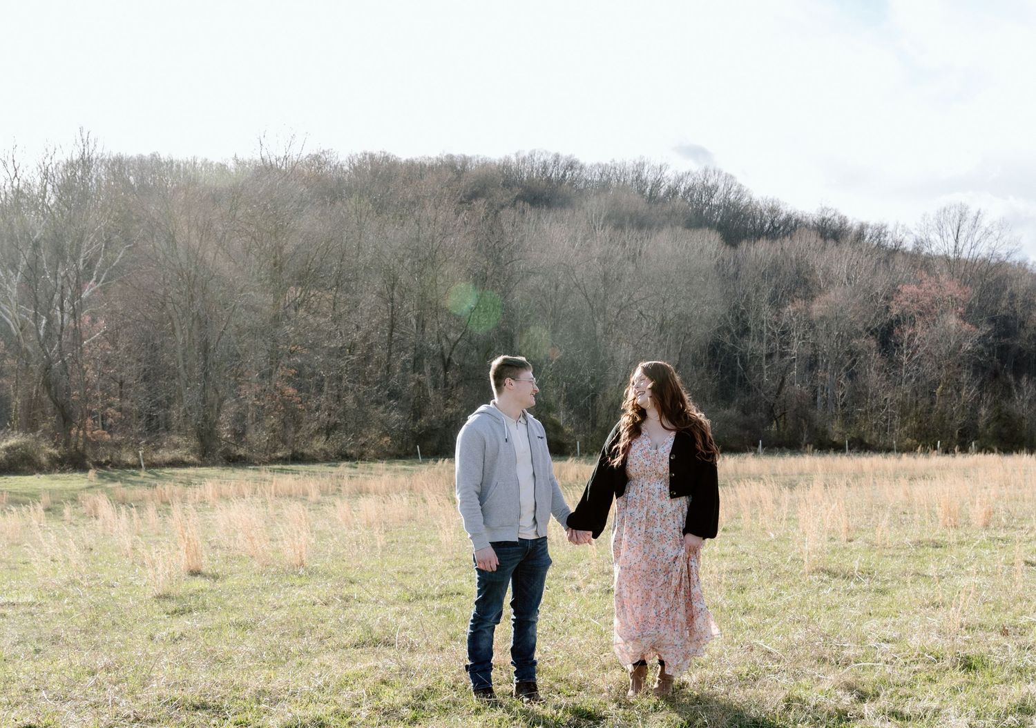 Multiple panoramic shots show a couple walking in a rural meadow or field setting during a photography session.