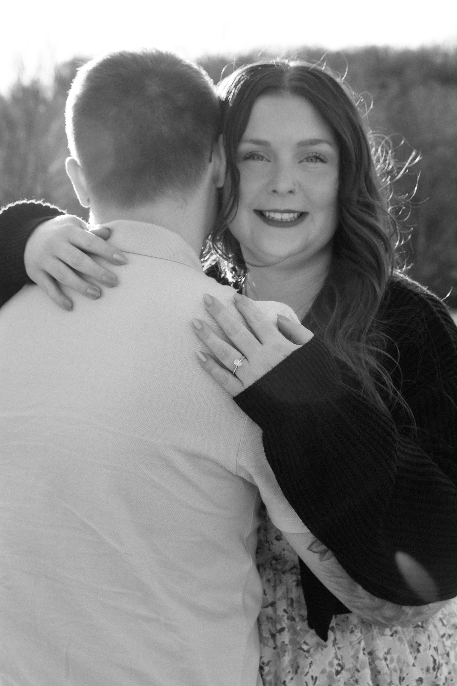 Romantic black and white photo sequence of a couple embracing outdoors.
