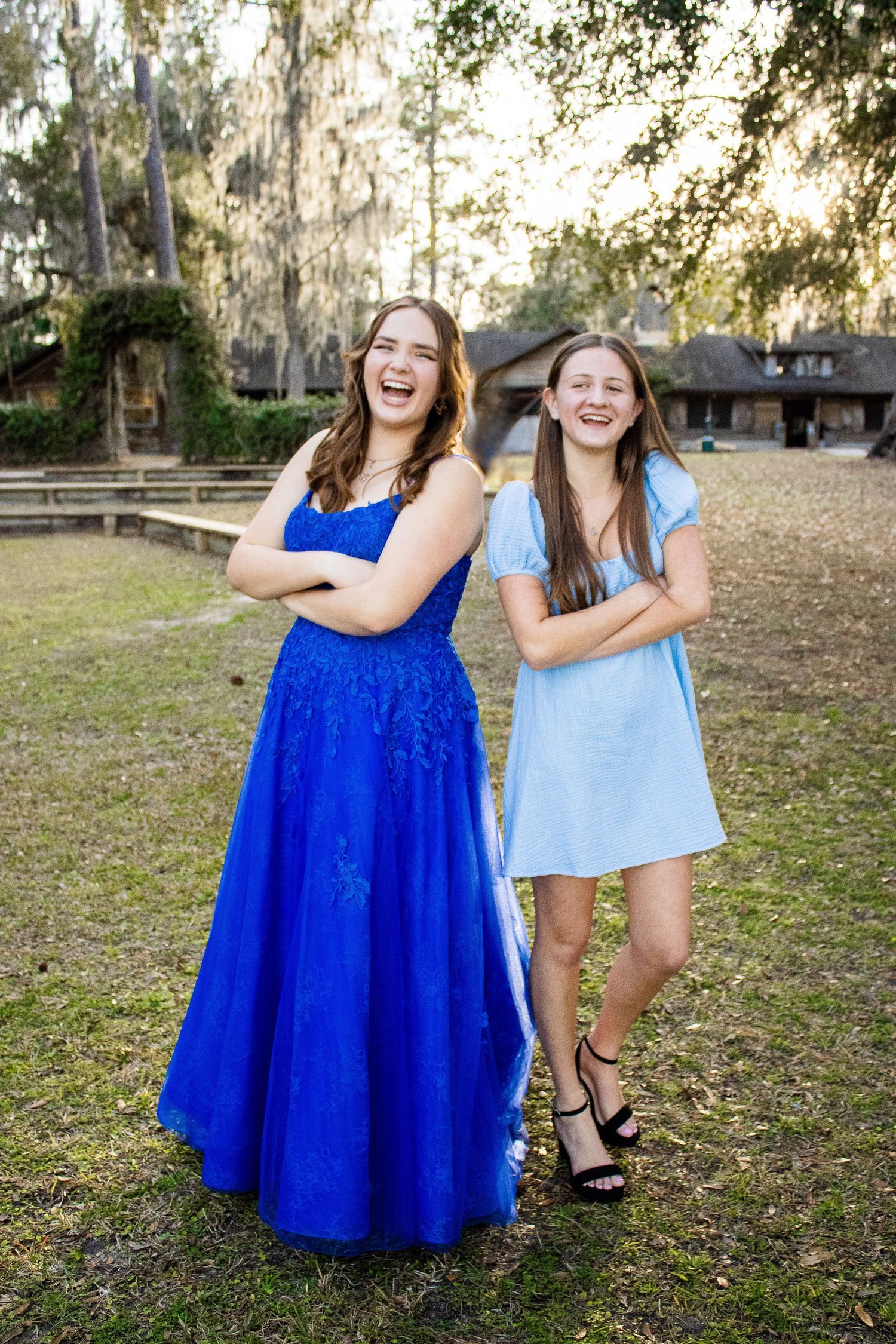 Friends standing back to back with arms crossed, laughing and smiling together to celebrate her Sweet 16.