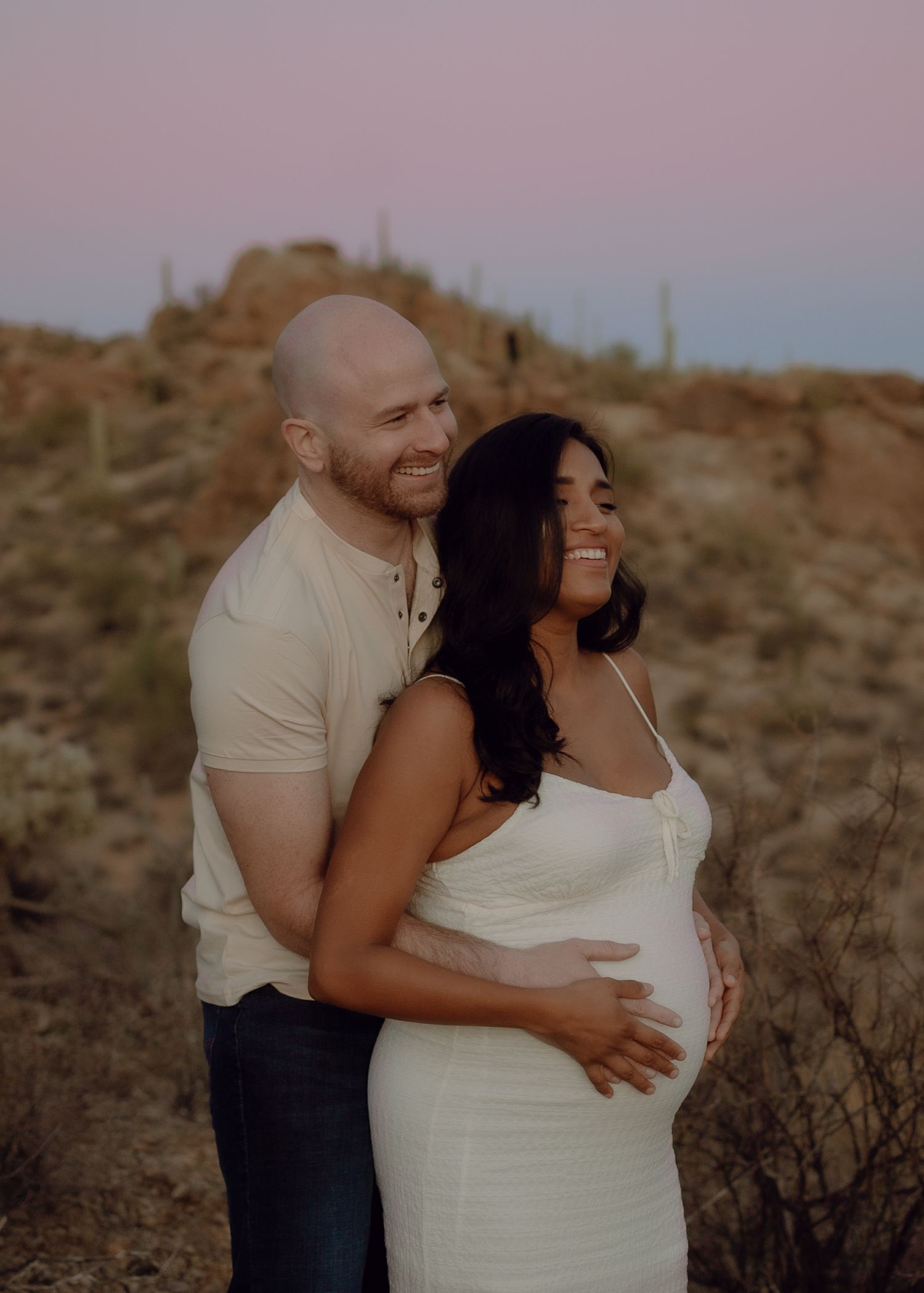 Arizona maternity photography — glowing mom-to-be in scenic outdoor setting, gates pass Tucson