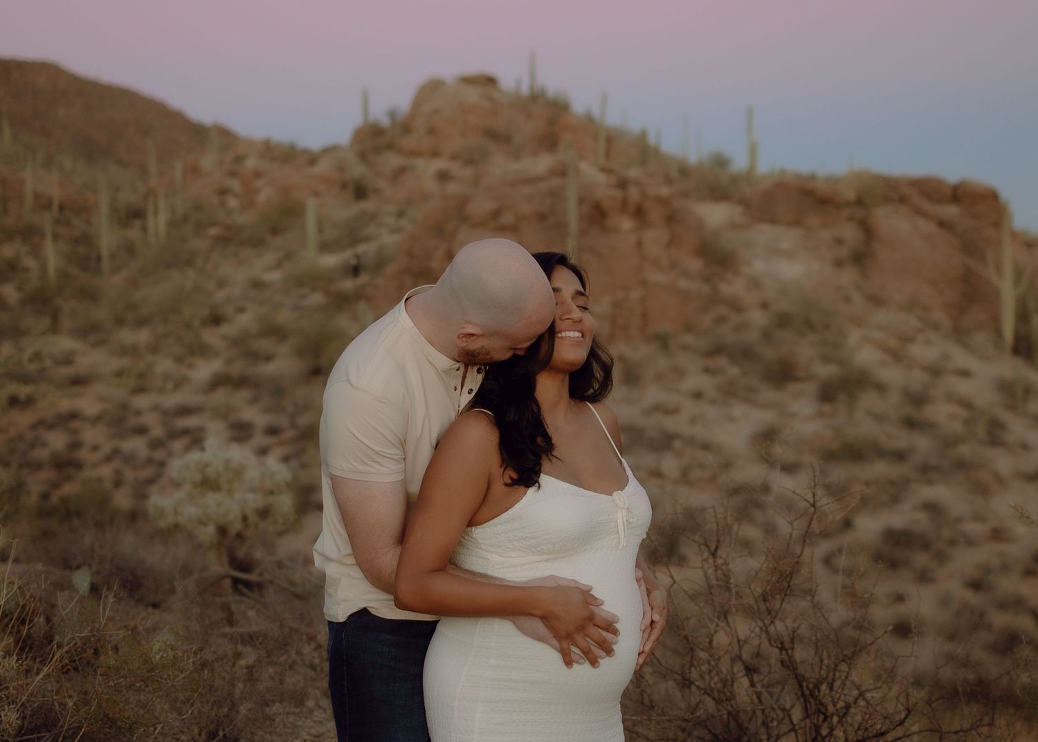 Arizona maternity photography — glowing mom-to-be in scenic outdoor setting, gates pass Tucson