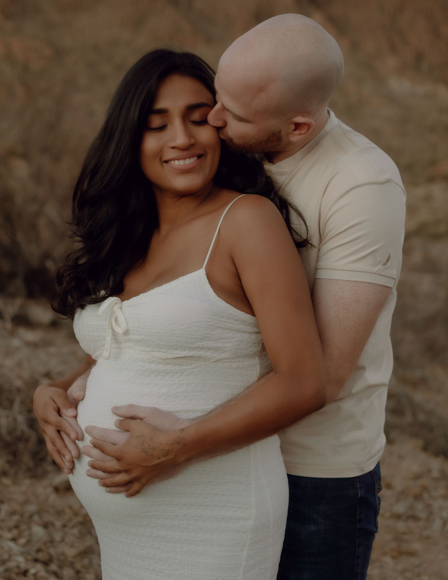 Arizona maternity photography — glowing mom-to-be in scenic outdoor setting, gates pass Tucson