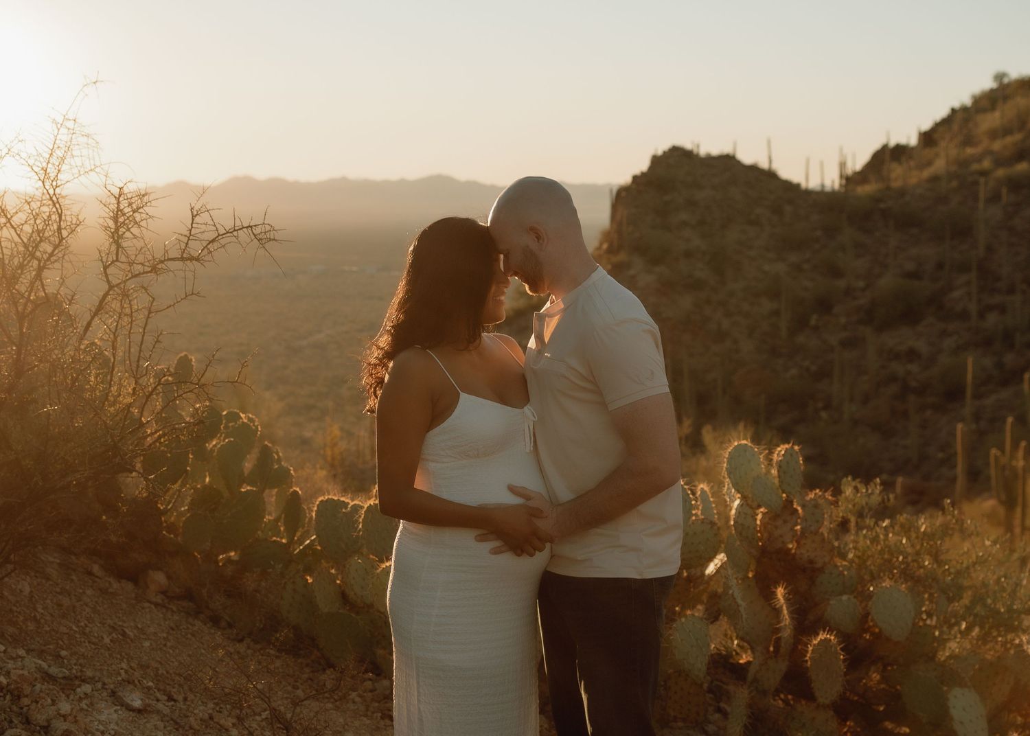 Arizona maternity photography — glowing mom-to-be in scenic outdoor setting, gates pass Tucson