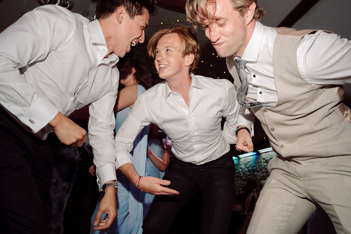A series of candid party photos showing people dancing and socializing at a casual indoor event.