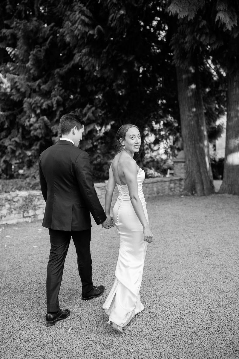 A black and white photo sequence shows a couple in formal attire playfully dancing together on grass.