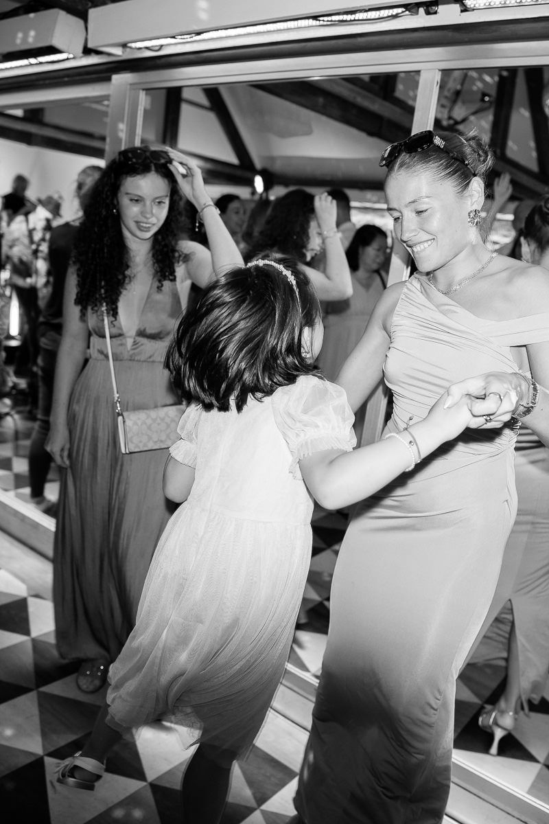 Black and white sequence of photos showing couples dancing together at a wedding reception.