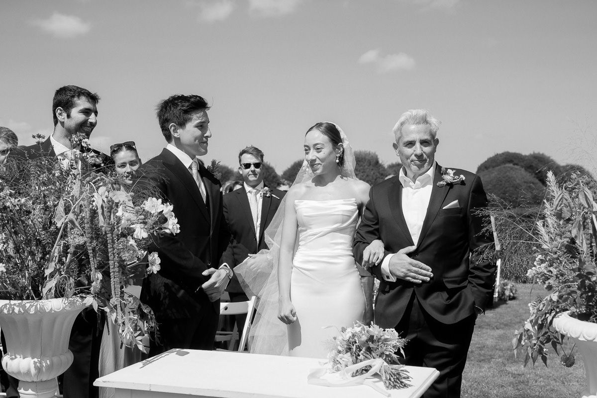 A series of black and white wedding photos showing celebration moments at an outdoor reception.