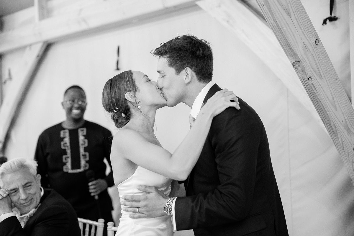 A series of black and white wedding photographs showing intimate moments between couples during their celebration.