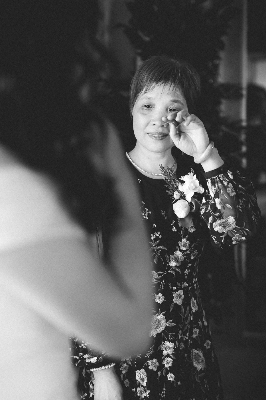 A series of black and white portraits showing someone wearing a floral patterned outfit in different candid poses.