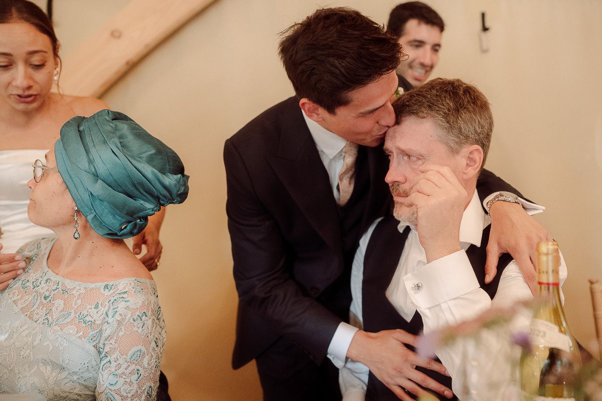A series of candid wedding moments showing couples embracing and celebrating during an indoor reception.